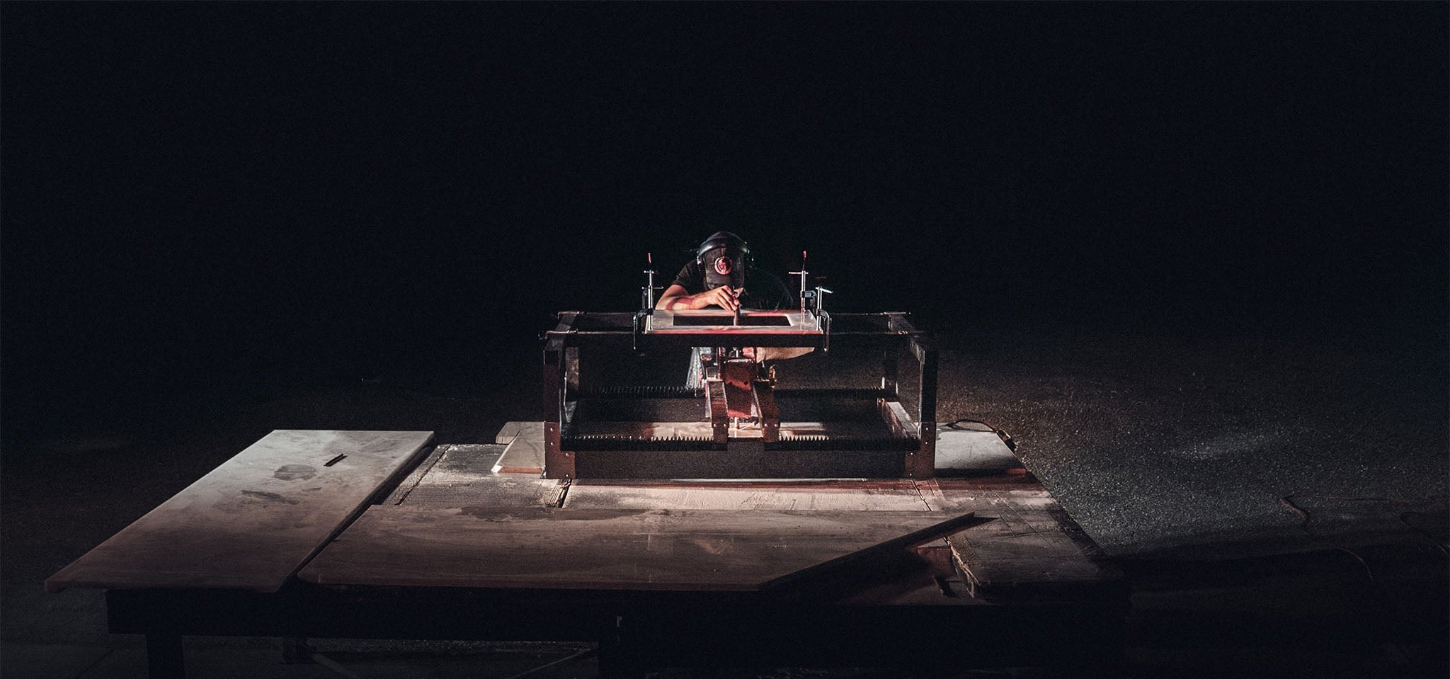 worker using sink ripper stone router to cut out sink out of taj mahal granite